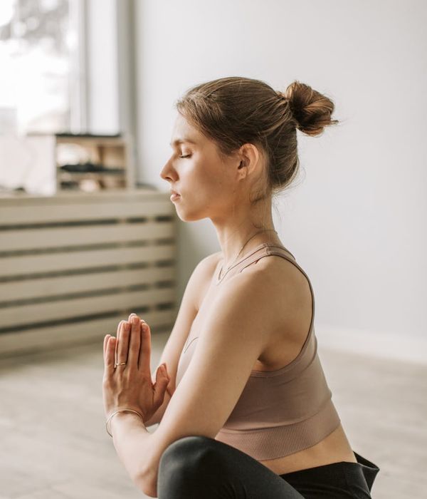 Woman with a calm expression gently focusing her eyes, symbolizing clarity and well-being.